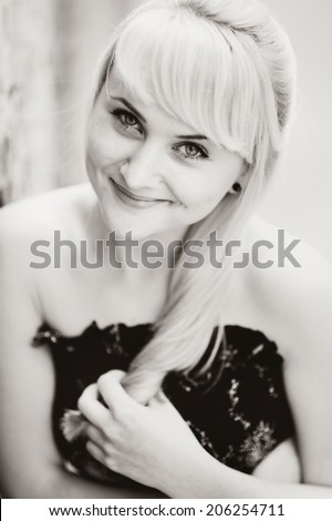 Black and white portrait of a blond woman in black dress. Summer girl.