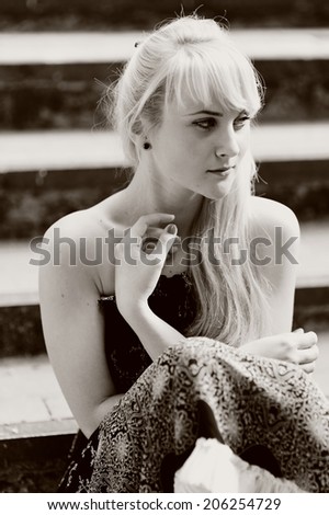 Black and white portrait of a blond woman in black dress. Summer girl.