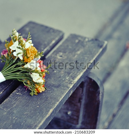 Wedding bouquet on wood surface. Summer wedding. Vintage picture.