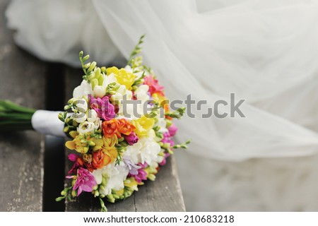 Wedding bouquet on wood surface. Summer wedding.