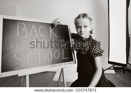 Sad school kid with blackboard