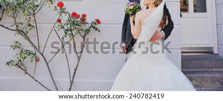 just married couple posing near the flowers