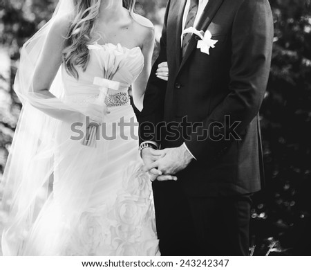 Newlywed couple standing together, happy family in black and white.