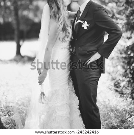 Newlywed couple standing together, happy family in black and white.