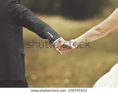 Marry me today and everyday. Newlywed couple holding hands, wedding picture.