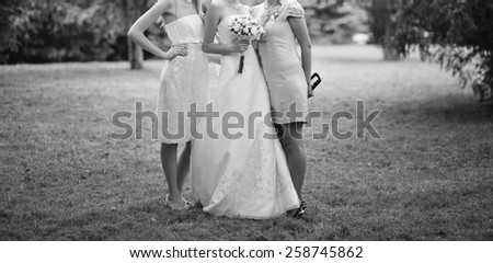 Beautiful bride with bridesmaids. Wedding picture in black and white.