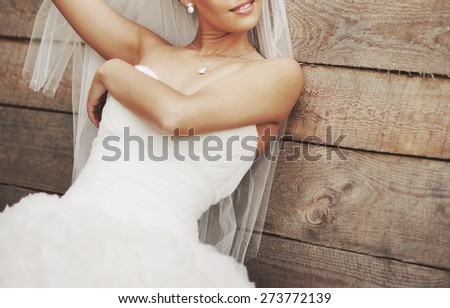 Wedding picture of happy bride outside.
