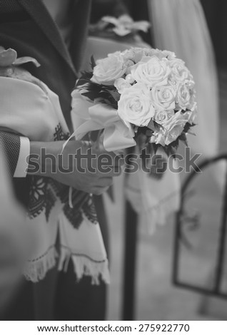 Groom with bouquet about to meet bride.