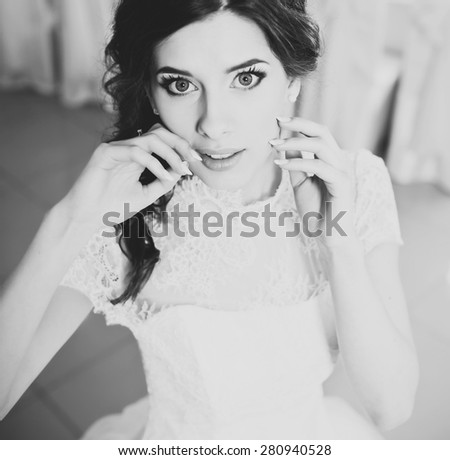 Happy bride posing. Wedding portrait of beautiful fiance in black and white.