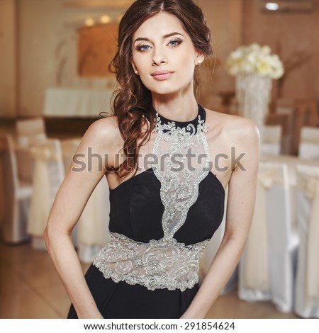 Teenage girl wearing fancy prom dress, posing on  school-leaving party.