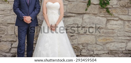 Wedding summer couple together posing against brick wall.