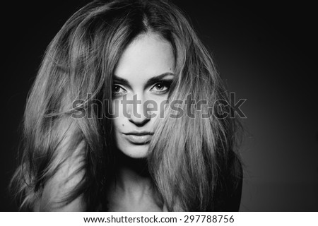 Fashion black and white portrait of young log hair woman.