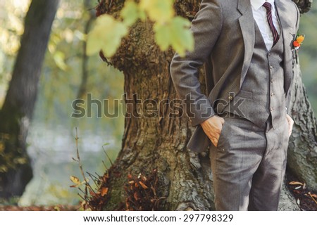 Wedding couple in forest next to big old tree.  Groom and bride together.