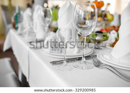 Wedding banquet  table with dishware and meal,  waiting for bride and groom.