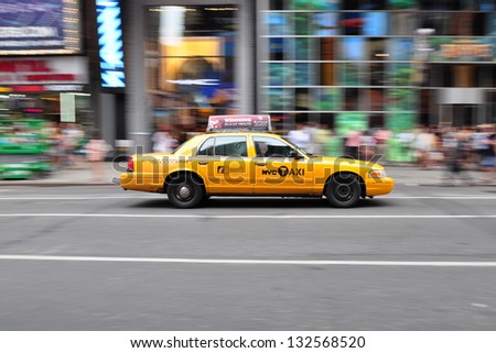 NEW YORK, USA - JULY 4, 2012: Panning shot of a NYC Taxi at Times Square, New York.