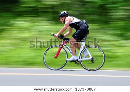 SKYLINE DRIVE, USA - JUNE 16, 2012: Panning shot of a man riding his bicycle at Skyline Drive, Shenandoah National Park, USA.