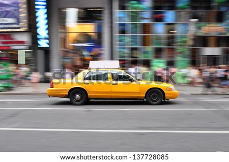Panning shot of a NYC Taxi Cab at Times Square, New York.
