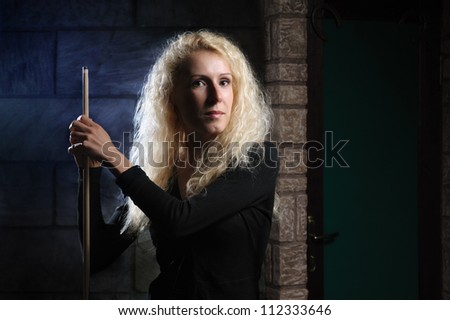 Woman is holding a billiards cue