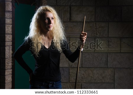 Woman is holding a billiards cue