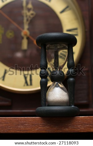 old-fashioned hourglass and clock