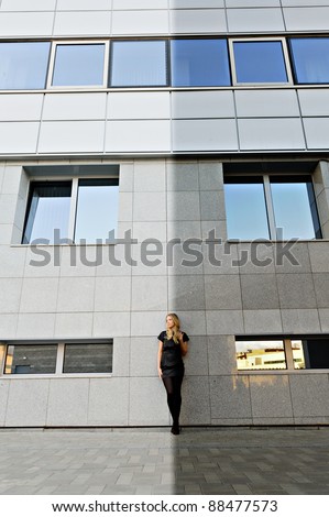 City girl is standing at the light and shadow border