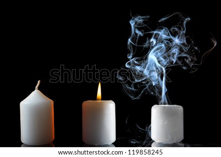 Three candles: new, burning and with smoke