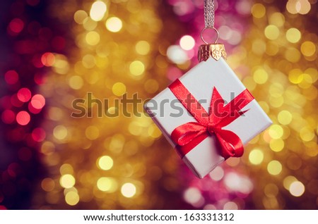 Gift box with red ribbon on abstract background