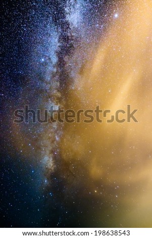 A picture of the milkyway galaxy behind thin cloud. Processed by stacking multiple exposure into one picture. Contain noise.