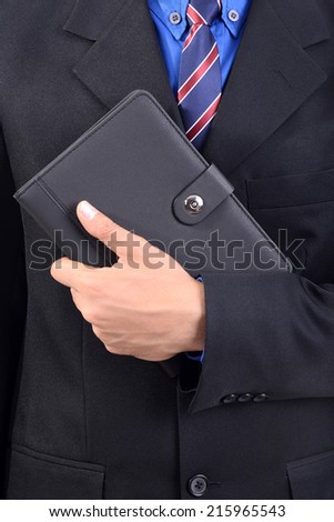 Businessman holding business book in hand