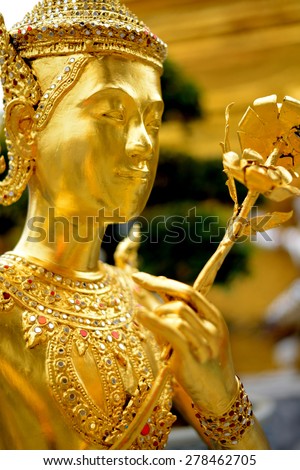Picture from Wat Phra Kaew famous place and landmark of Thailand, Thai Woman and gold flower at Grand Palace Bangkok province