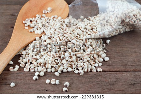 Millet the organic grain food in wood spoon on wood table.