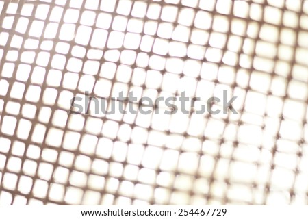 Blurred bamboo net filtered to gray tone. Defocused photo.