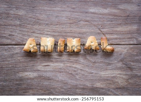 Animal text with cookies and blank space on the wooden background