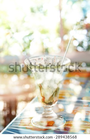 Creative double exposure cup of ice-cream combined with blured bokeh background
