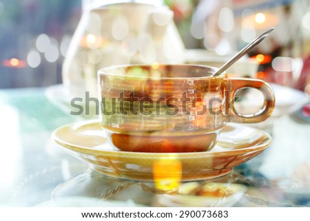 Creative double exposure cup of coffee combined with blured bokeh background
