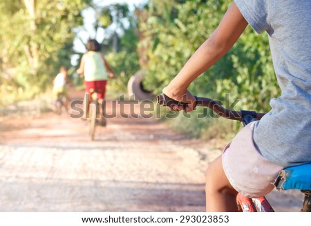 Asian children On Cycle Ride In Countryside.Focused on hand.