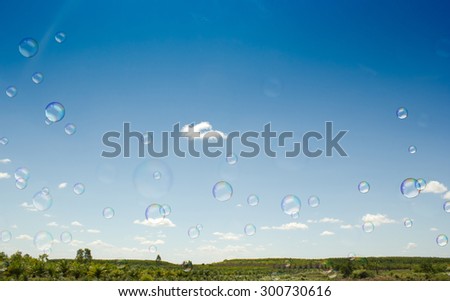 Soap bubbles on blue sky background.