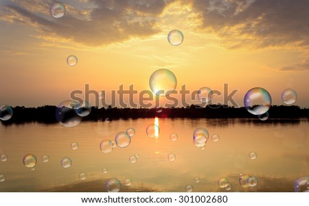 Soap bubbles on Gold light on sun set with light on the river.