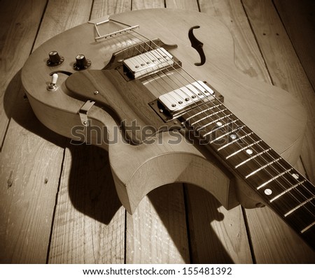 vintage jazz guitar on wooden background