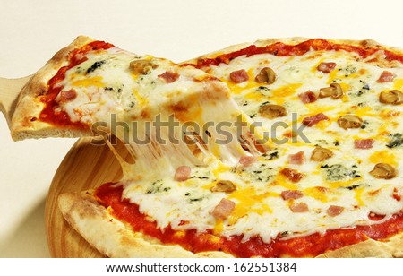 serving a four cheese pizza with melted cheese