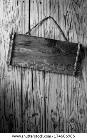 black and white old wooden signboard on aged wood