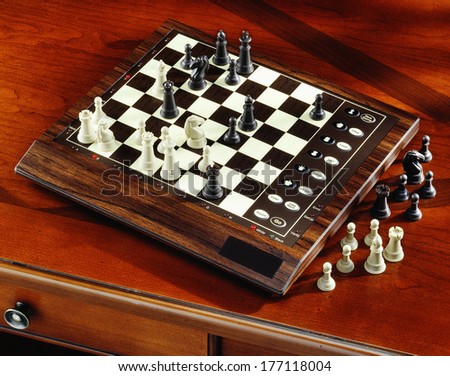 electronic chess computer on wooden desk