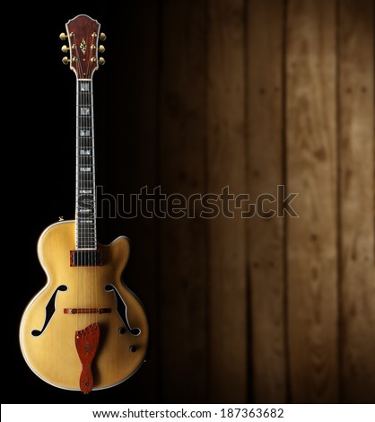 jazz guitar on dark wooden background