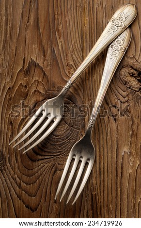 vintage silver forks on aged wood