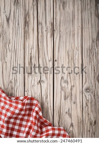 old kitchen wooden table background with classic red squares napkin