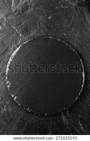 black slate plate on black slate background
