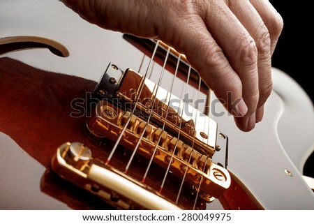 hand of guitarist playing an electric guitar