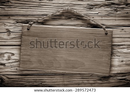 light wood rustic signboard on aged wooden wall, vintage image