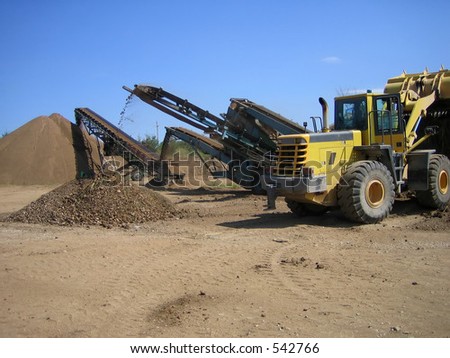 Loader and crusher on site at gravel pit