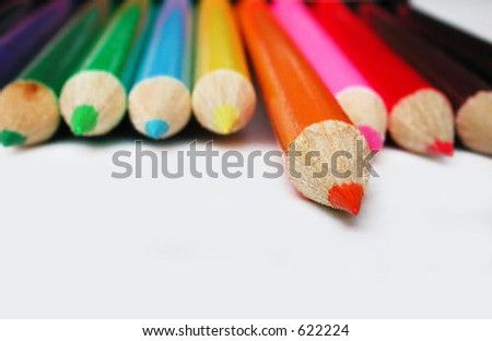 orange pencil crayon isolated from other colorful pencil crayons
